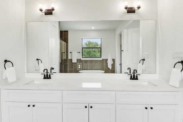 bathroom featuring vanity and a shower with shower door