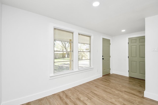 spare room with recessed lighting, light wood-style flooring, and baseboards