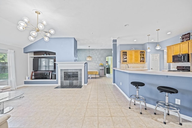 kitchen featuring electric stove, pendant lighting, light countertops, open floor plan, and black microwave