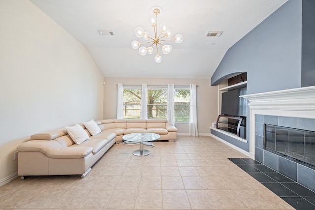 living area featuring visible vents, vaulted ceiling, a tiled fireplace, and light tile patterned flooring