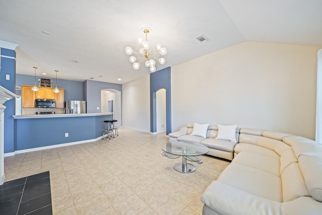 living area featuring baseboards, visible vents, arched walkways, lofted ceiling, and a notable chandelier