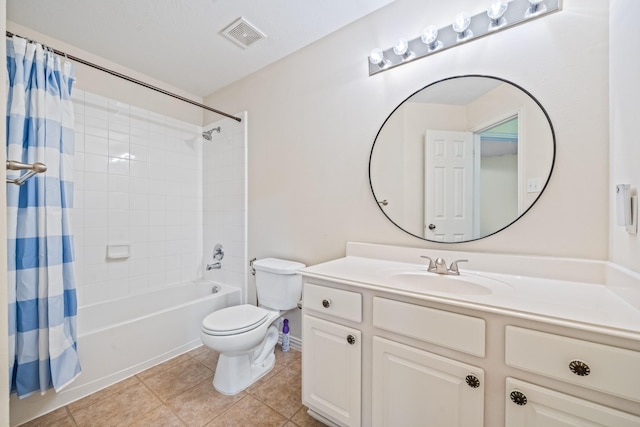 bathroom featuring toilet, tile patterned floors, vanity, visible vents, and shower / tub combo with curtain