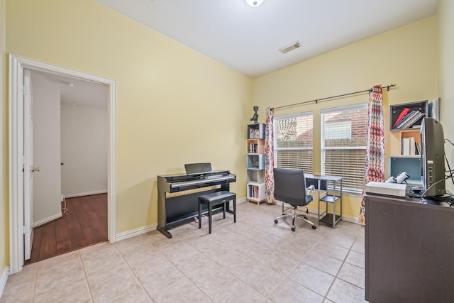 office featuring light tile patterned floors, baseboards, and visible vents