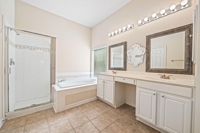 full bath with a garden tub, double vanity, a stall shower, a sink, and tile patterned flooring