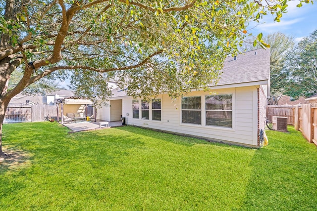 rear view of property with a yard, a shingled roof, central AC unit, a pergola, and a fenced backyard