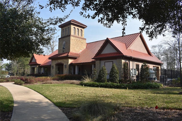 exterior space with stone siding, a yard, a standing seam roof, and metal roof