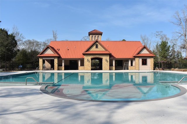 pool featuring a patio area and fence