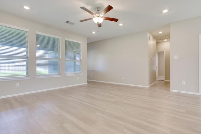 spare room featuring baseboards, visible vents, a ceiling fan, light wood-type flooring, and recessed lighting