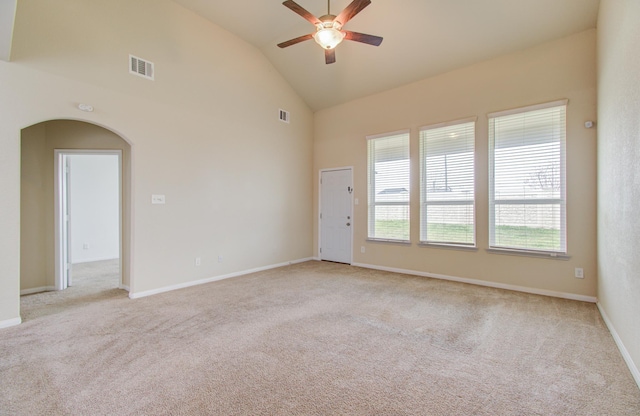 carpeted spare room with high vaulted ceiling and ceiling fan