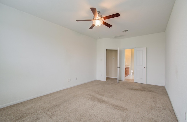 spare room with ceiling fan and light colored carpet