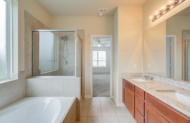 bathroom featuring tile patterned flooring, plus walk in shower, and vanity