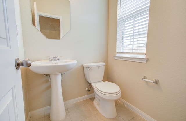 bathroom featuring toilet and tile patterned flooring