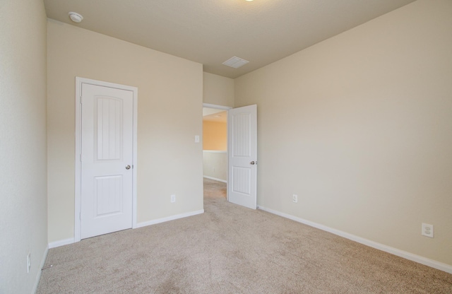 unfurnished bedroom with light colored carpet