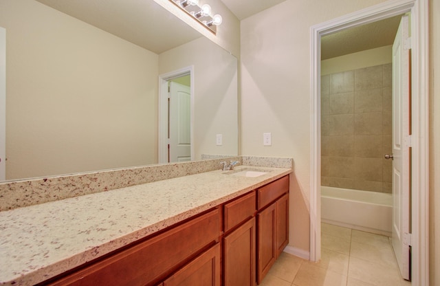 bathroom featuring vanity, tiled shower / bath combo, and tile patterned floors