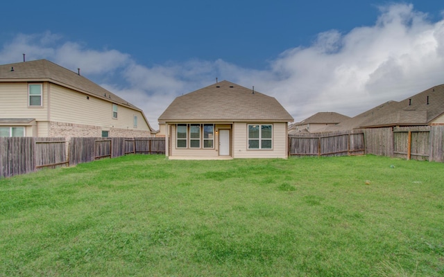 rear view of house with a yard