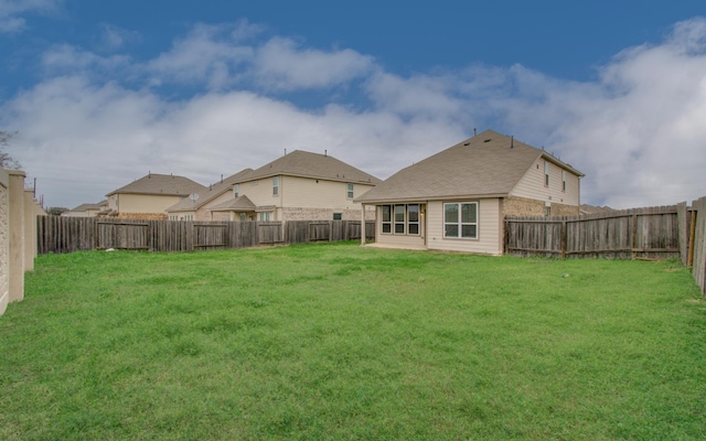 back of house featuring a lawn