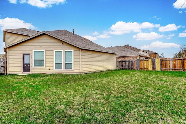 rear view of property featuring a yard