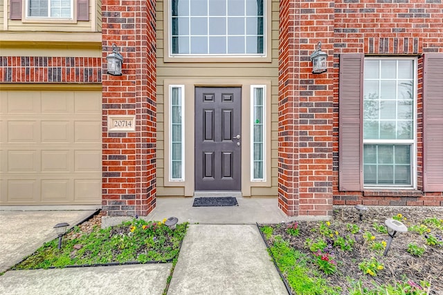 doorway to property with a garage