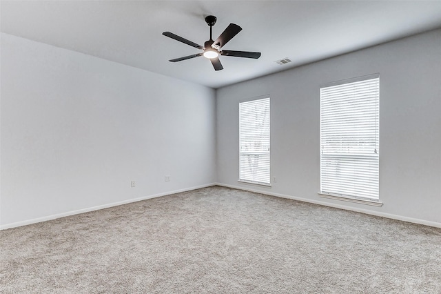 unfurnished room featuring light colored carpet and ceiling fan