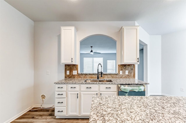 kitchen featuring dishwasher, sink, and white cabinets