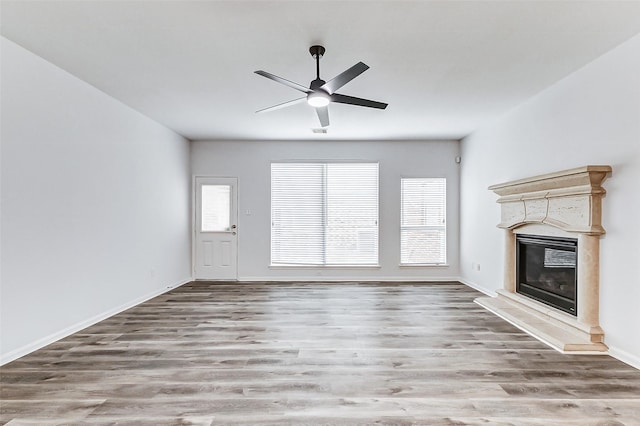 unfurnished living room with ceiling fan and hardwood / wood-style floors