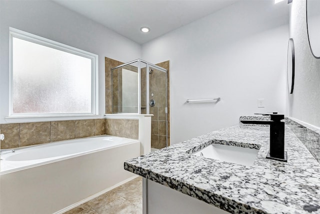 bathroom with vanity and separate shower and tub