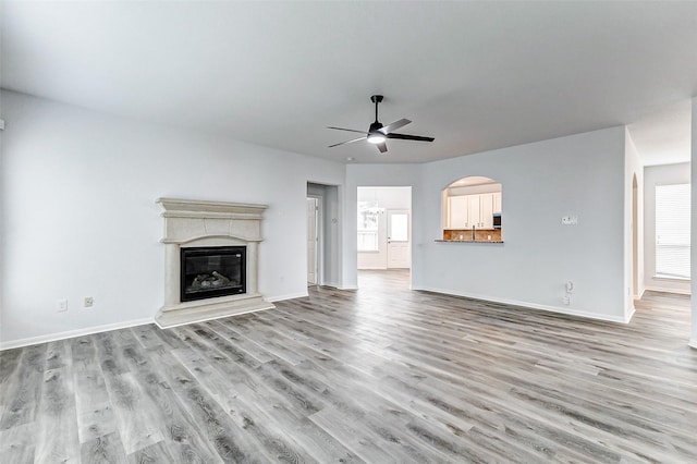 unfurnished living room with ceiling fan, light hardwood / wood-style flooring, and a wealth of natural light