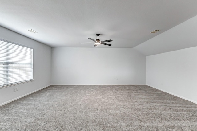 unfurnished room featuring vaulted ceiling, carpet floors, and ceiling fan