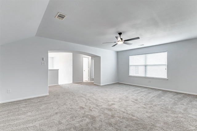 spare room with ceiling fan, lofted ceiling, and light colored carpet