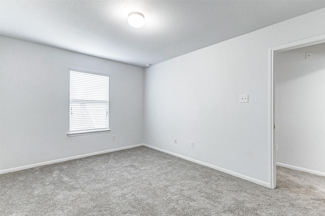 unfurnished room featuring light colored carpet