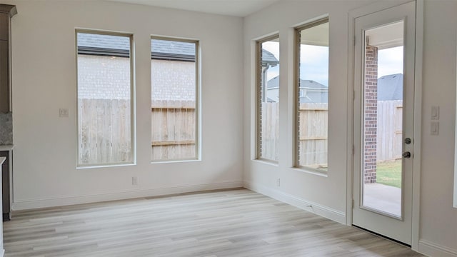 unfurnished dining area with plenty of natural light and light wood-type flooring