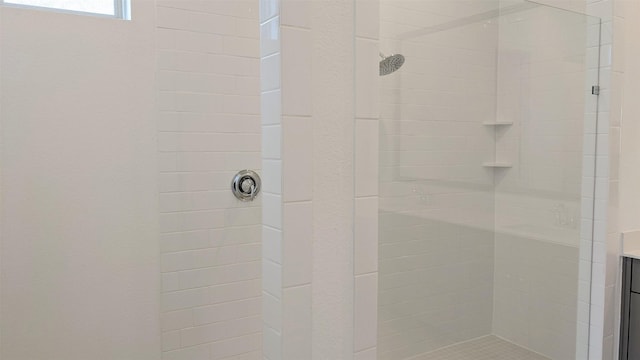 bathroom with vanity and tiled shower