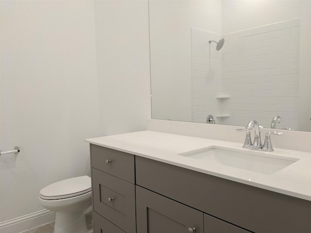 bathroom with vanity, toilet, tile patterned flooring, and a shower