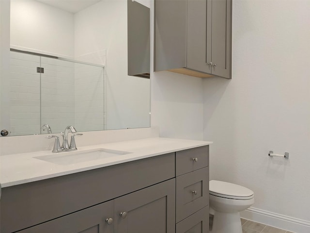 bathroom with vanity, an enclosed shower, and toilet