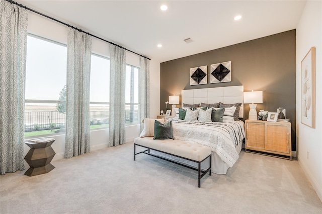 carpeted bedroom with multiple windows