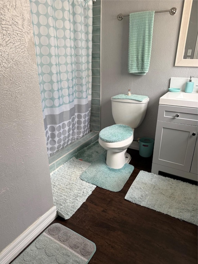 bathroom featuring vanity, a shower with curtain, toilet, and hardwood / wood-style floors