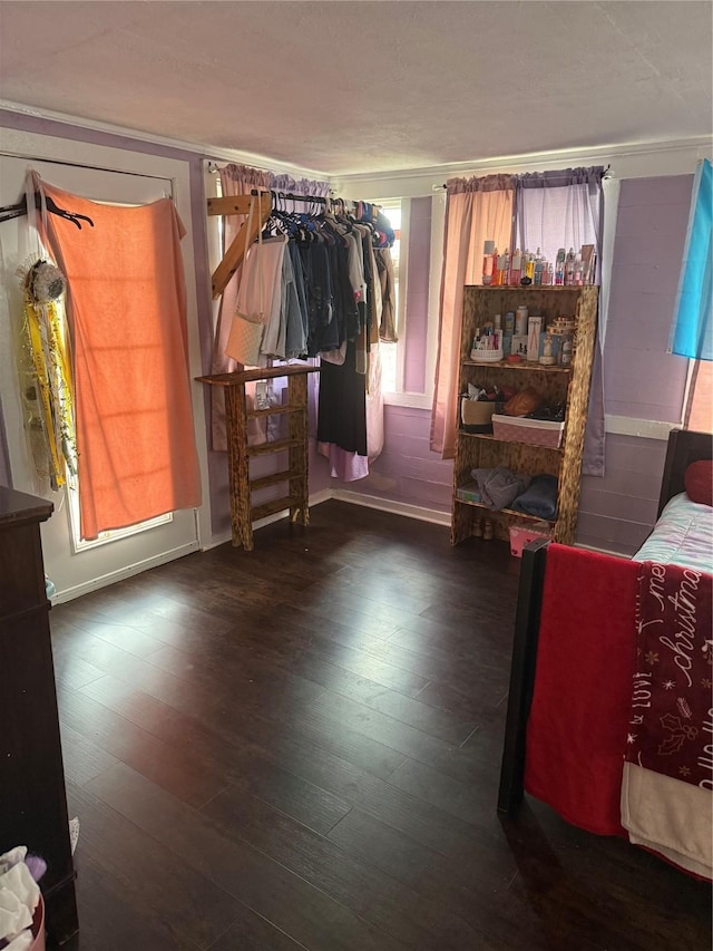 bedroom with dark wood-type flooring