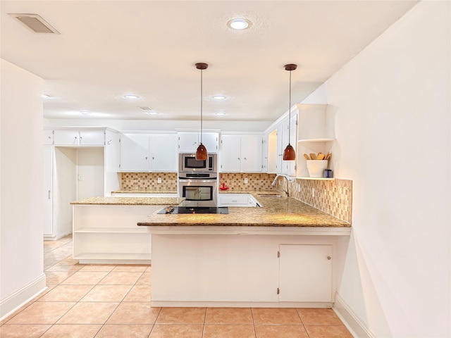 kitchen with sink, decorative light fixtures, light tile patterned floors, appliances with stainless steel finishes, and kitchen peninsula