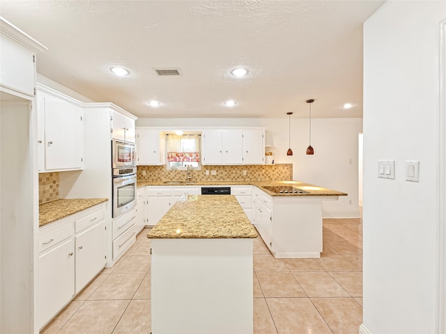 kitchen with pendant lighting, white cabinetry, a kitchen island, and black appliances