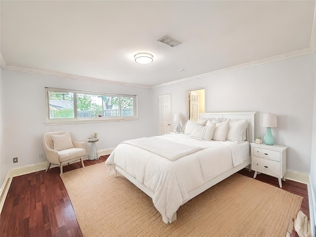 bedroom with crown molding and dark wood-type flooring