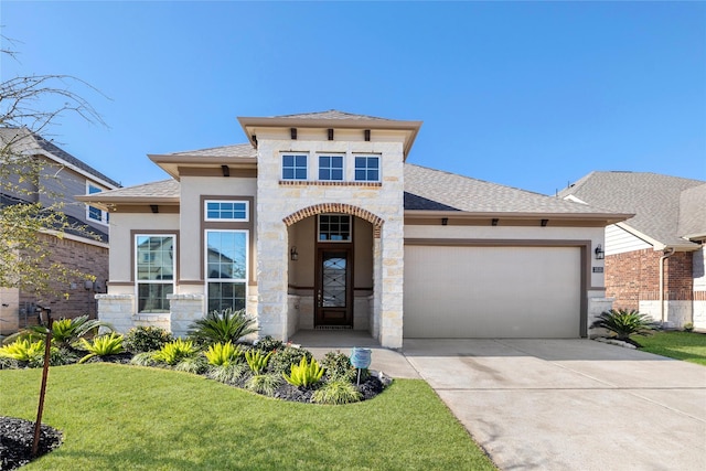 view of front facade featuring a garage and a front yard