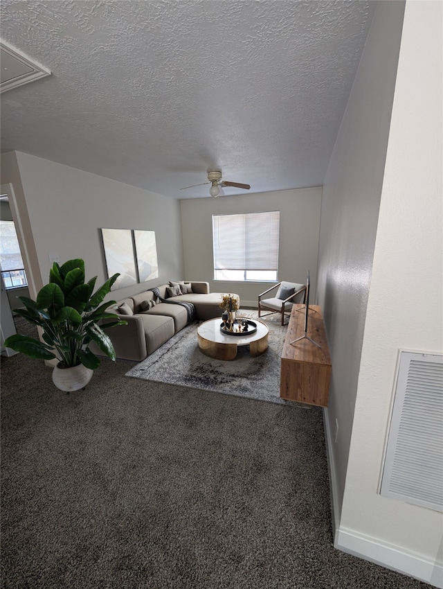 living area with plenty of natural light, attic access, and carpet floors