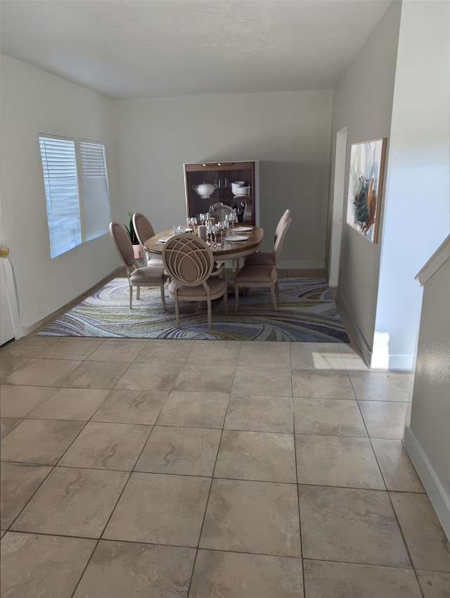 9767 Farrell Dr, Houston, TX 77070 - dining area featuring baseboards and tile patterned flooring