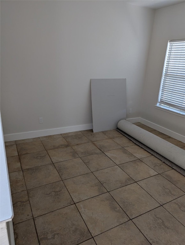 9767 Farrell Dr, Houston, TX 77070 - tiled spare room featuring baseboards