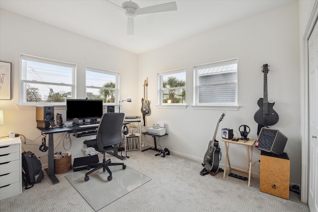 office area with a ceiling fan, baseboards, and carpet flooring