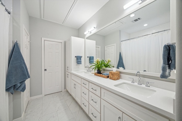 full bathroom with marble finish floor, baseboards, visible vents, and a sink