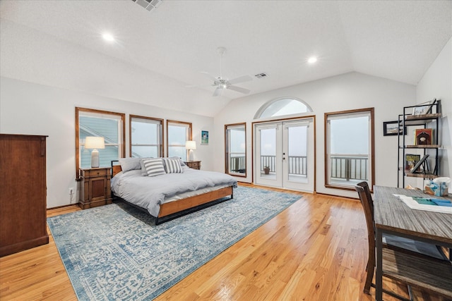 bedroom with lofted ceiling, visible vents, light wood-style floors, access to outside, and french doors