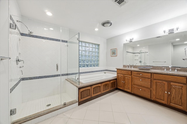 bathroom featuring a garden tub, a shower stall, visible vents, and a sink