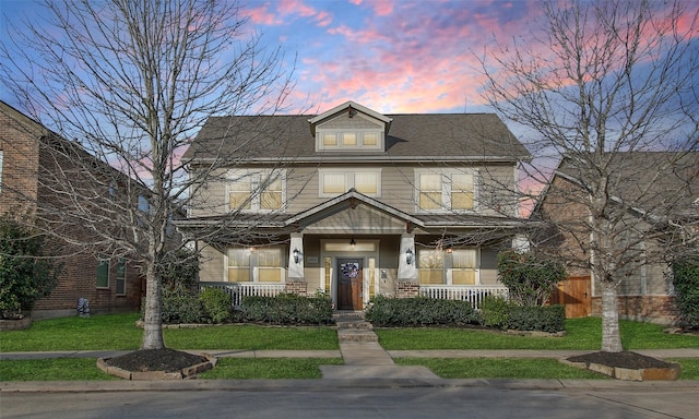 view of front of home with a yard and a porch