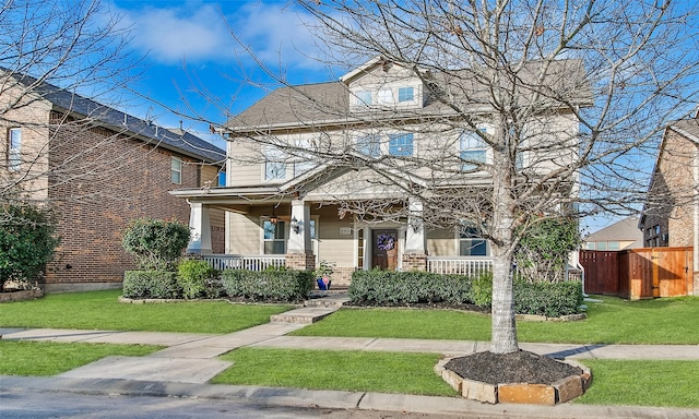 view of front of home with covered porch and a front yard